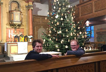 Verabschiedung zu Lüttje Wiehnachten: Hendrik Hundertmark (links) und Rainer Müller-Jödicke vor dem großen Weihnachtsbaum in der Martinskirche. Foto: Andrea Hesse