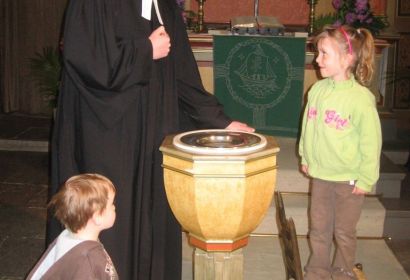 Sophie Schmidt will sich am Sonntag durch Pastor Rainer Müller-Jödicke an ihre Taufe erinnern lassen, und Bruder Jan schaut zu.